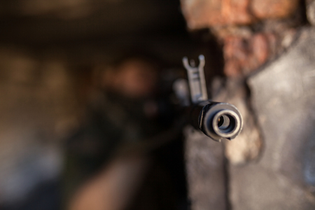 Soldier in war, with weapons in his hands, aim at the enemyの写真素材
