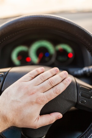 Mans hand on the wheel of the carの写真素材
