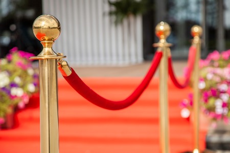 Golden rope barrier with red event carpetの写真素材