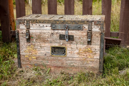 Old wooden storage chest on the grassの写真素材