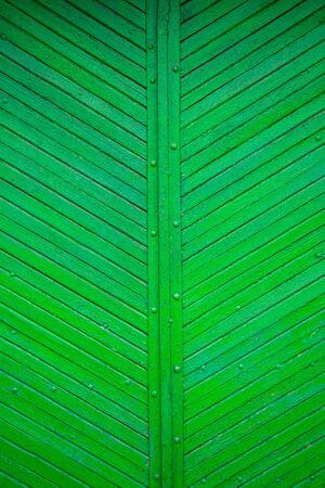 The texture of the old green board located diagonally.の写真素材