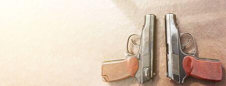 The gun lies on a table on old village boards, legalization of weapons. Crime problems. Weapons for sports and self-defense. Conceptual of violence, homicide, crime and burglary. Copyspaceの写真素材