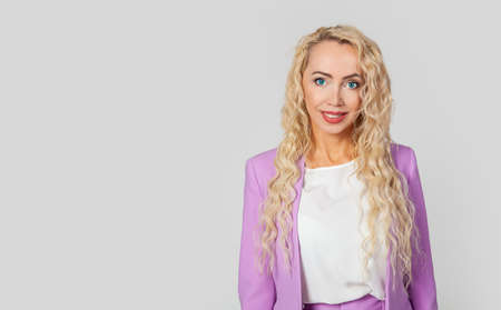 Attractive beautiful business European woman smiling with delight girl with long hair studio shotの写真素材