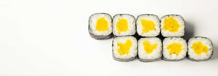 Sushi roll with takuan on a white plate, classic Japanese sushi. Traditional Japanese food with maki. Delicious pieces of sushi. For the restaurant menu copyspaceの写真素材