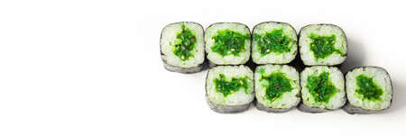 Sushi roll with chuka on a white plate, classic Japanese sushi. Traditional Japanese food with maki. Delicious pieces of sushi. For the restaurant menu. copyspace.の写真素材