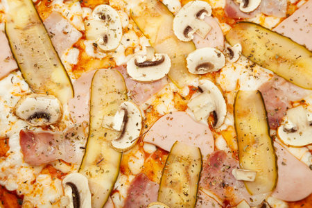 The texture of a delicious meat pizza served on a wooden plate, the ingredients are the signature sauce, mozzarella cheese, ham, bacon, pickled cucumber, champignons on white. Pizzeria promotion poster.の写真素材