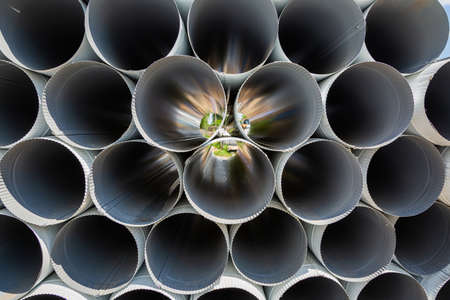 Downpipe warehouse. Steel pipes, parts for the construction of a roof drainage system in a...