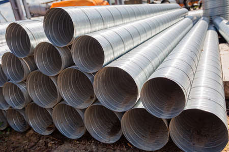 Ventilation pipe warehouse. Steel pipes, parts for the construction of air ducts for an industrial air conditioning system in a warehouse. Industrial airway ventilation equipment and piping systemsの写真素材