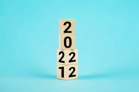 Wooden Blocks With changing number 2021 2022. New year concept. Copy space. Cube block flipping from...