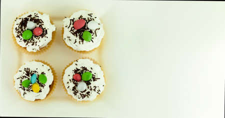 Cupcakes with colored on a white plate
