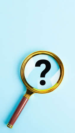 Magnifying glass with question mark symbol on blue background. T