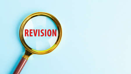 Magnifying glass with the word REVISION. Word writing text Revisの写真素材