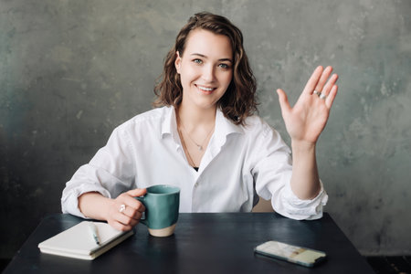 Businesswoman in the Digital Age: Engaging in Video Conference from Home or Office - Emphasizing Modern Remote Communication and Work Practices.の写真素材