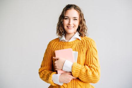 Happy young woman holding a digital tablet. Perfect for online education, e-learning courses,...