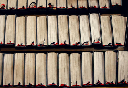 Stacked vintage books with worn edges and bookmarks, top view. Warm tones, academic and literary theme. ideal for literary and educational projectsの写真素材
