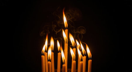 A group of burning yellow candles with flickering flames and smoke on a black background. Evokes a spiritual, solemn, or hopeful mood. Perfect for memorials, vigils, or meditation.の素材