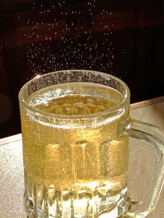Ginger ale fizzing in a glassの写真素材