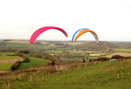 Butser Hill, Hampshire, England. 13th November 2019. Paragliders preparing to take off over the South Downs National Park.のeditorial素材