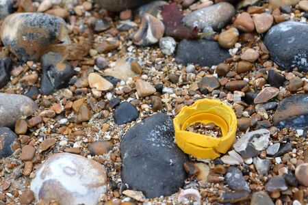 Plastic bottle cap on a beach. Environmental pollution
