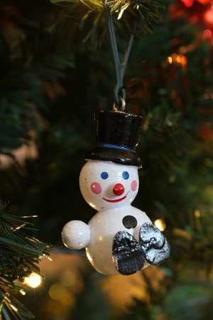 a one armed snowman on christmas tree