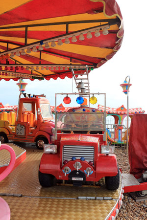 Bognor Regis, West Sussex, England - September 27 2022: Merry-go-round cars on the beach at Bognor