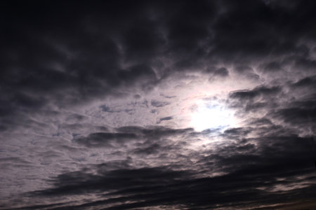 Dark storm clouds with sun breaking through.