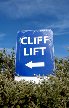 Blue sign pointing way to the top entrance of the Cliff Lift in Shanklin. Isle of Wight.の写真素材