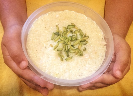 Child offering rice puddingの素材