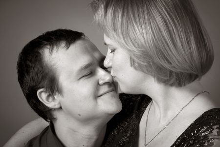 woman kisses her husband in the nose. Sepia. Close-up.の写真素材