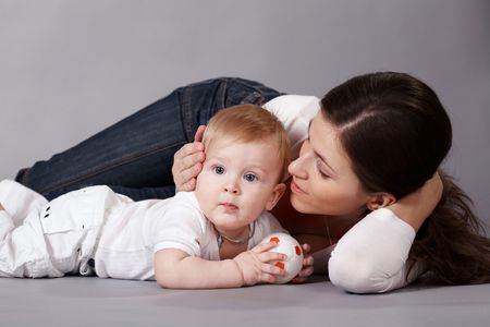 The woman lies with her small son, and stroked it.