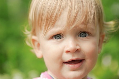 The little boy looks into the camera and smilesの写真素材