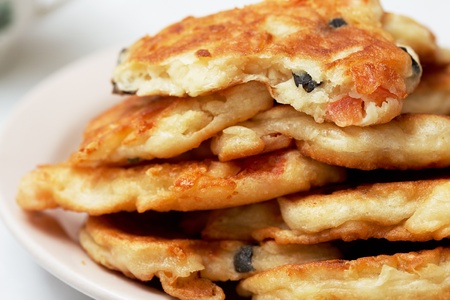 on a plate fried tortillas with olives and tomatoes