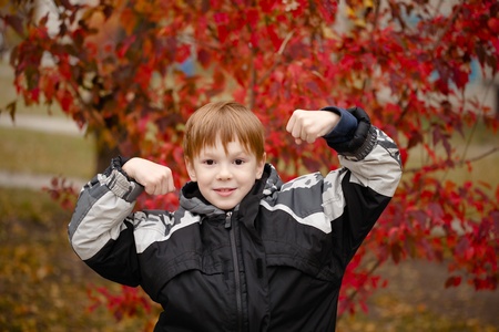 Boy in the jacket shows the biceps. Autumn.の写真素材