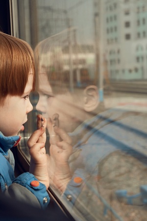 little boy looking out the train window