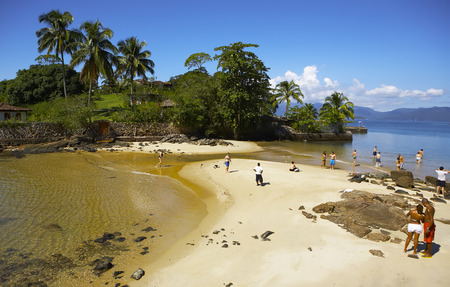Bright summer day in a quiet bay. Palm trees, beach, vacationers.のeditorial素材