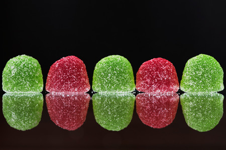 Red and green marmalade close-up on a black backgroundの写真素材