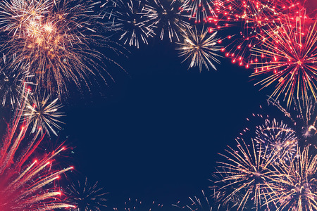 On a dark blue background are the multi-colored stars of fireworksの写真素材