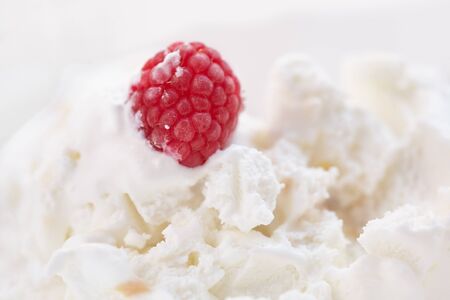 Red raspberries are in bowl with ice cream.の写真素材