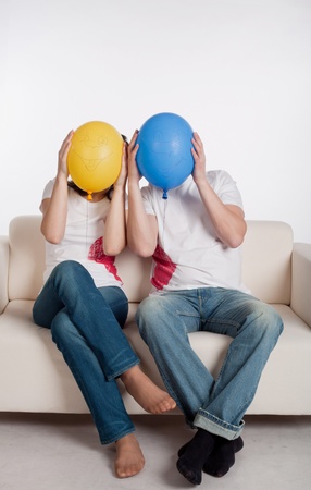 couple of young people playing with balloonsの写真素材