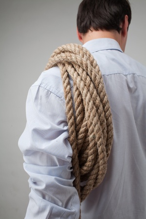 young man with a rope on his shoulderの写真素材
