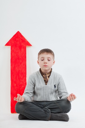 boy with an arrow pointing upの写真素材