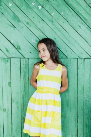 five-year-old girl in a green wooden wallの写真素材