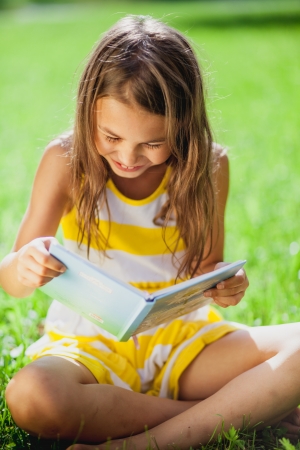 five-year-old girl reading a bookの写真素材