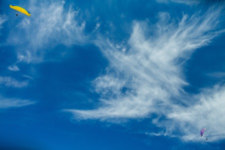 paragliders in the blue skyの写真素材