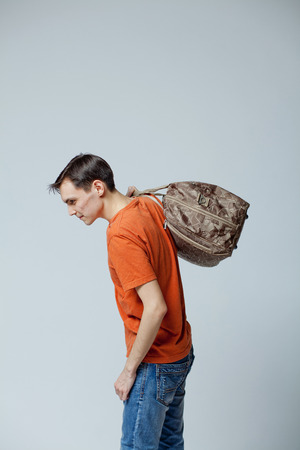 male student with bag, white background in studioの写真素材