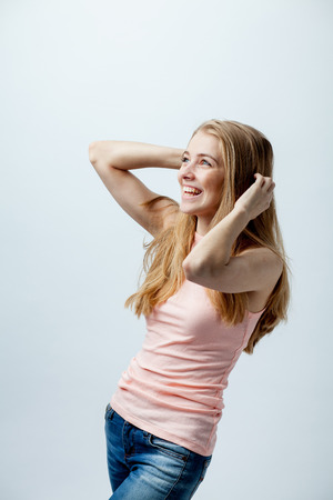 girl with his hands near his head in the studioの写真素材