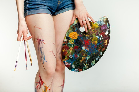 legs girl artist with his easel and brushesの写真素材