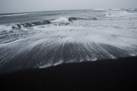 beach of black volcanic sand of the Pacific Ocean in Kamchatkaの写真素材