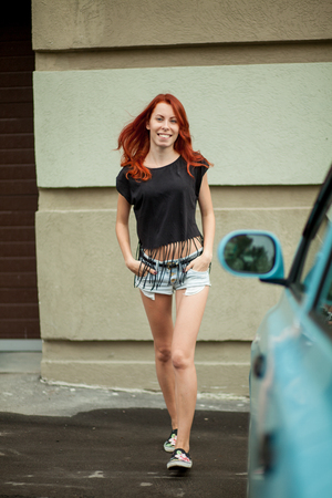 Young beautiful woman laughs on the streetの写真素材