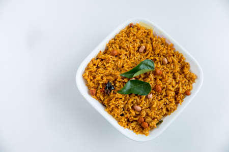 Spicy indian vegan/vegetarian food - tamarind flavored rice - Indian home cooked food with copy spaceの写真素材